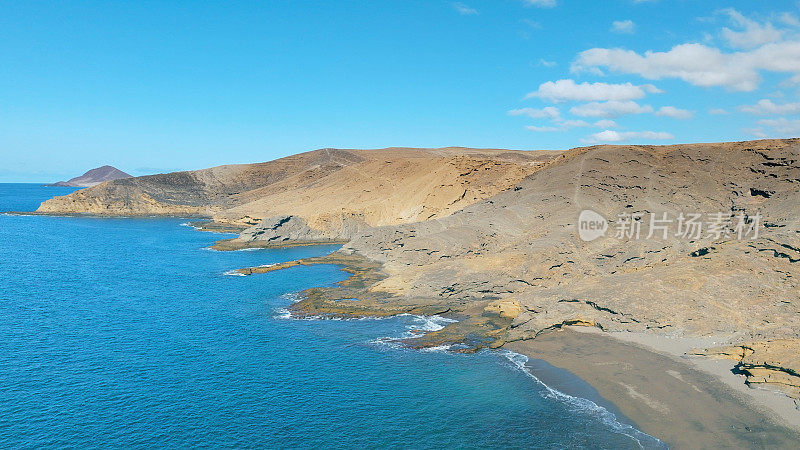 Aerial view of the beach "Playa Escondida" and the natural reserve of "Montaña Pelada" in Tenerife (Canary Islands). Drone shot